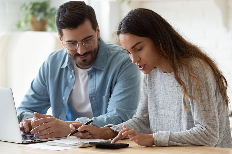 Couple doing research on computer